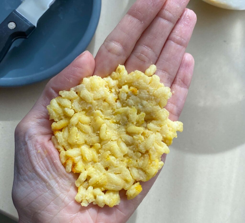 Sicilian Arancini Rice Balls adding flattening the rice
