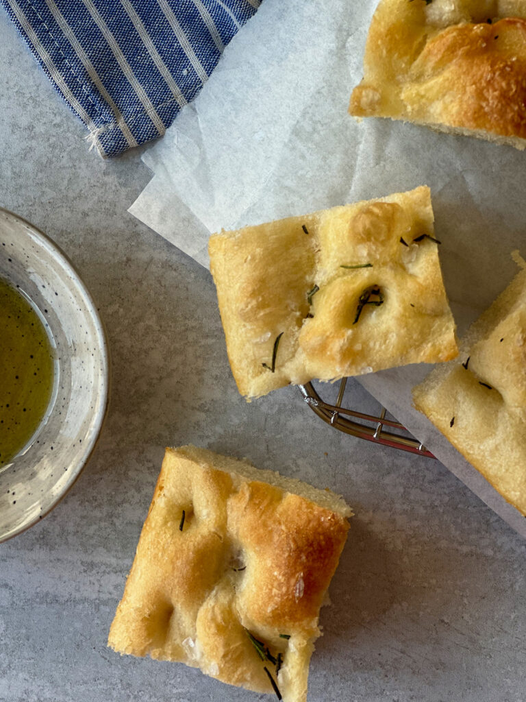 Close up view of focaccia squares on baking tray