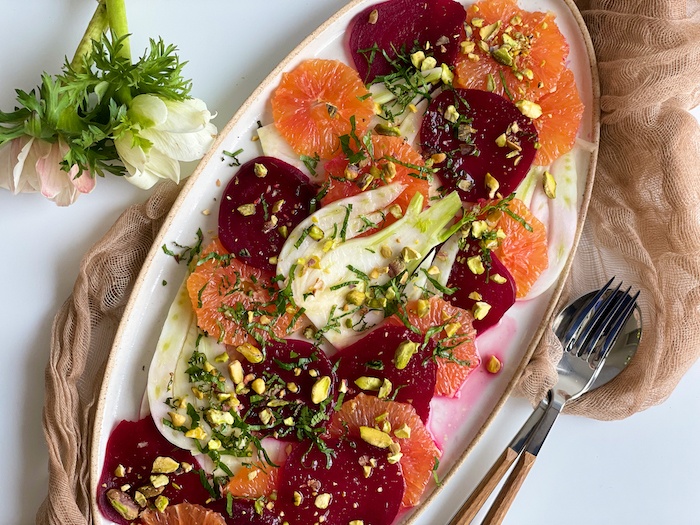 Final orange beet fennel salad on white plate
