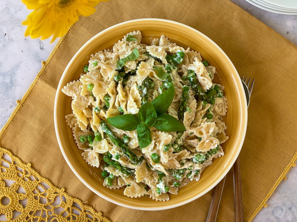 Ricotta and Green Pasta in a yellow bowl over a yellow napkin