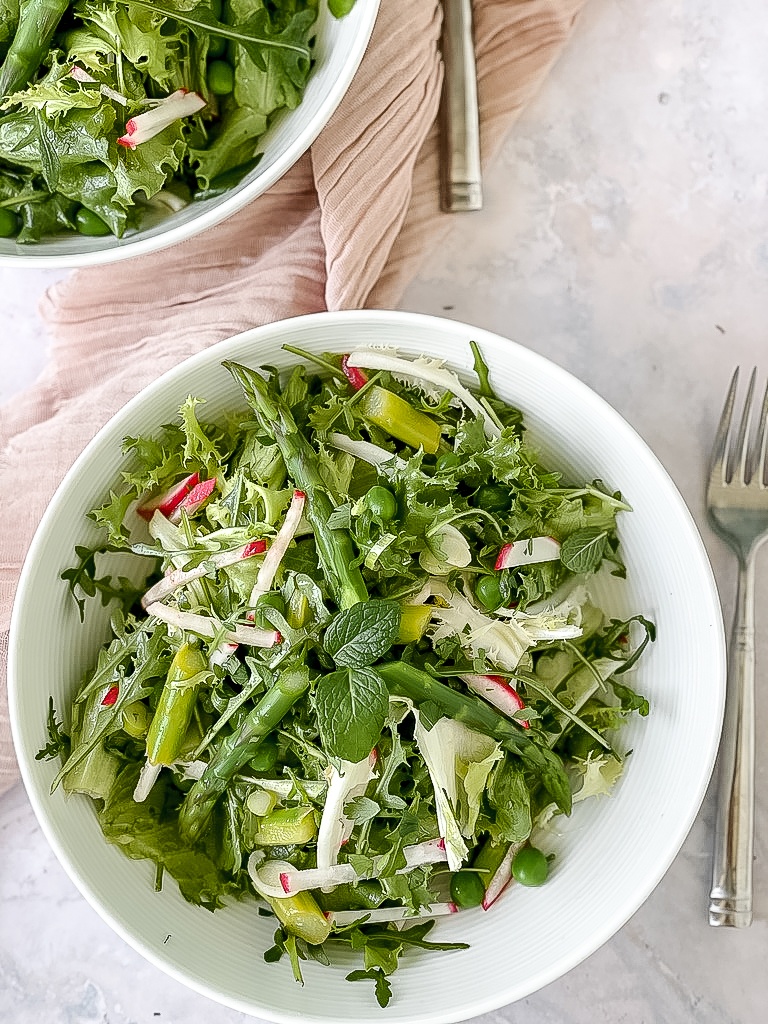Spring salad in a white bowl