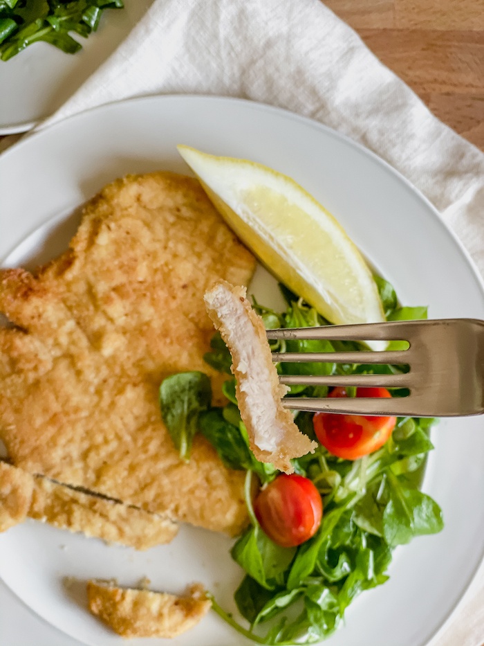 chicken cutlet bite in a fork