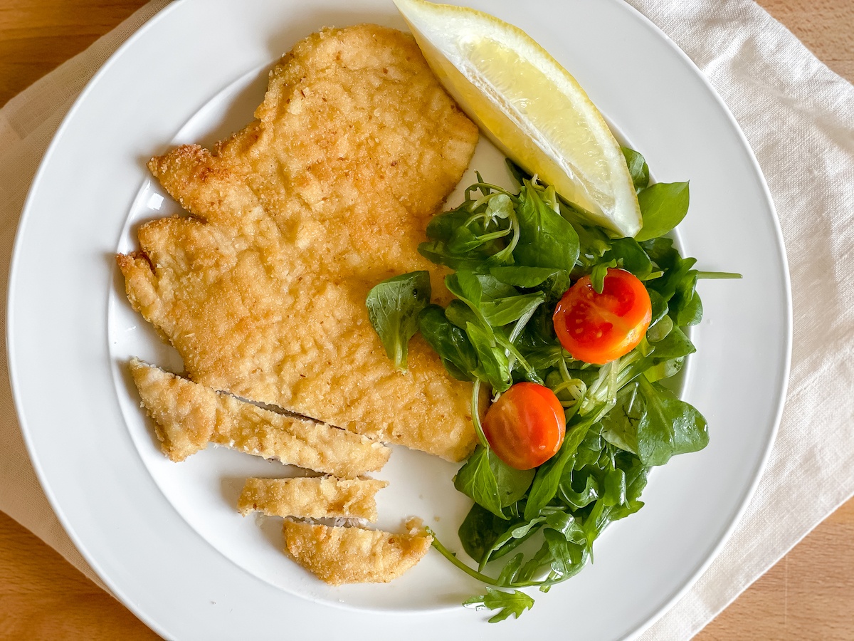 Pan-fried breaded chicken breast on a plate