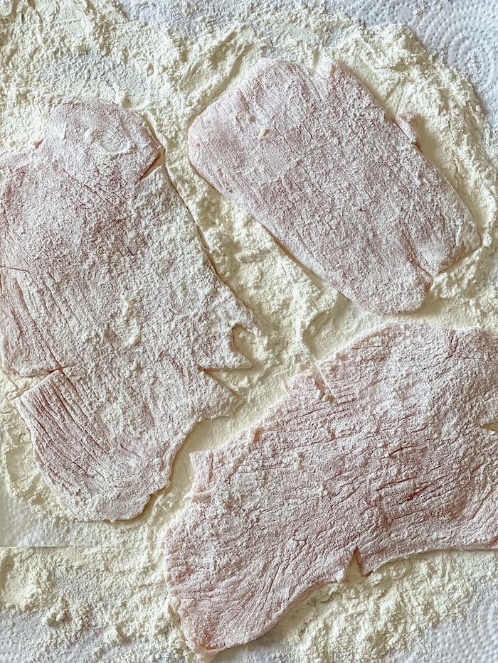 Coating chicken cutlets in flour