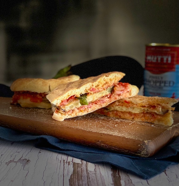 Caramelized Tomato Panini over a wooden board
