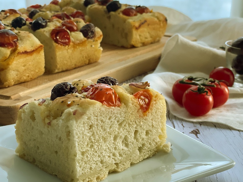 Focaccia with olives and tomatoes on a plate