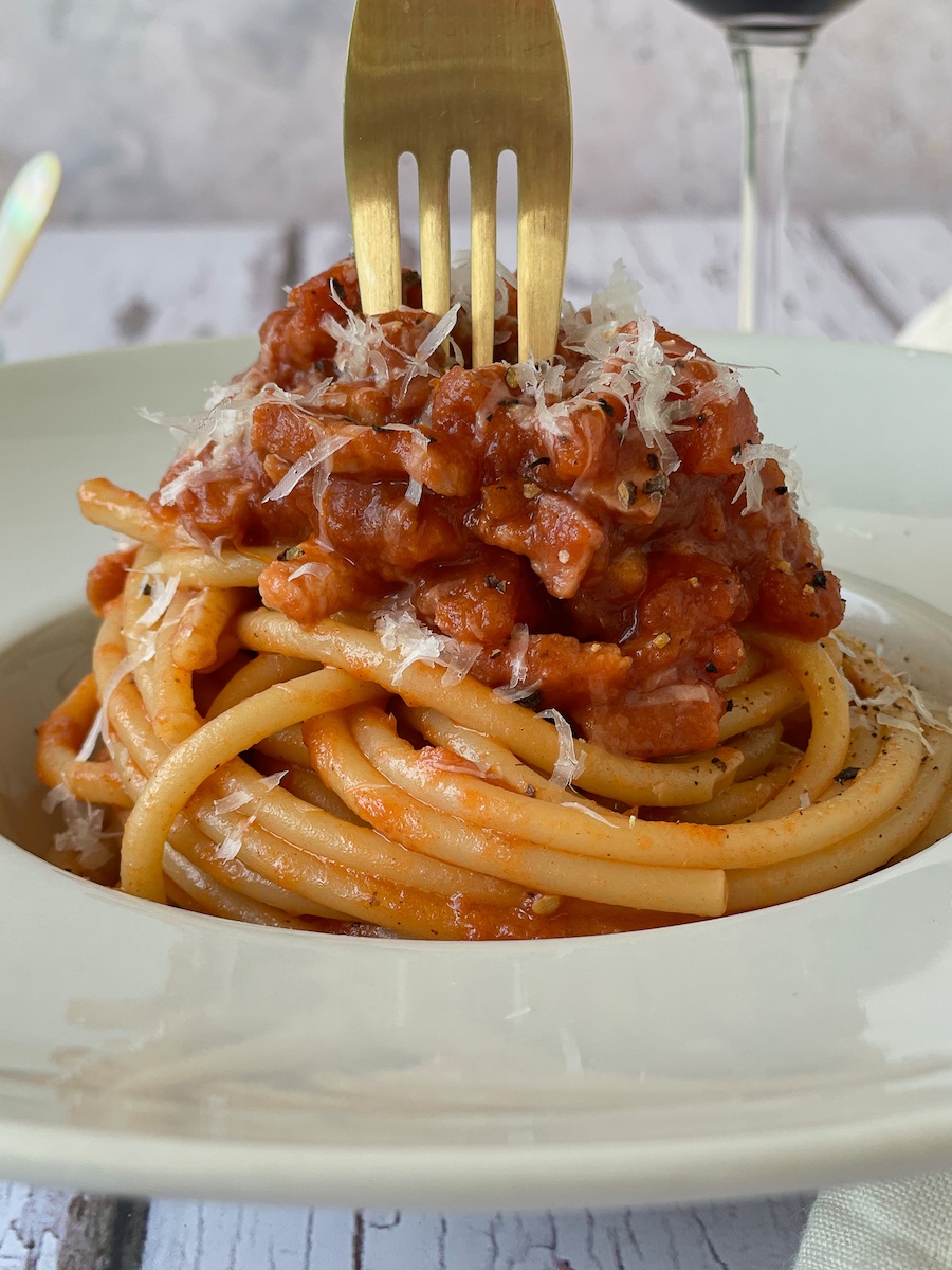 Authentic Italian Amatriciana Sauce on a plate of bucatini