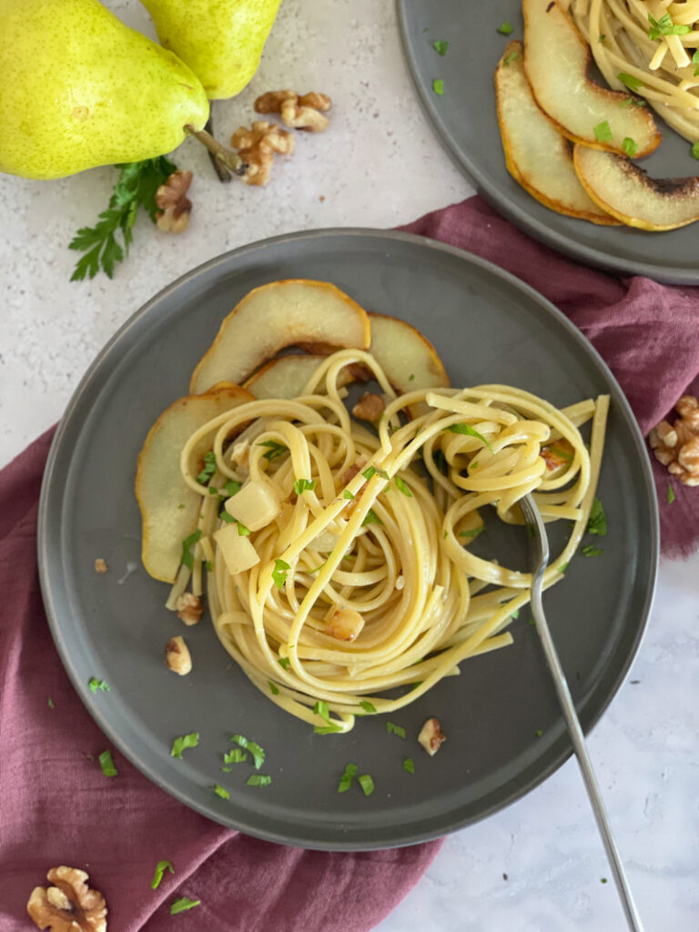 Gorgonzola Pear Walnut Spaghetti on. a grey playe