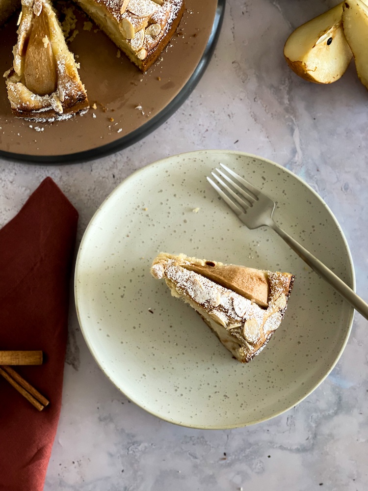Slice of pear cake on a white plate