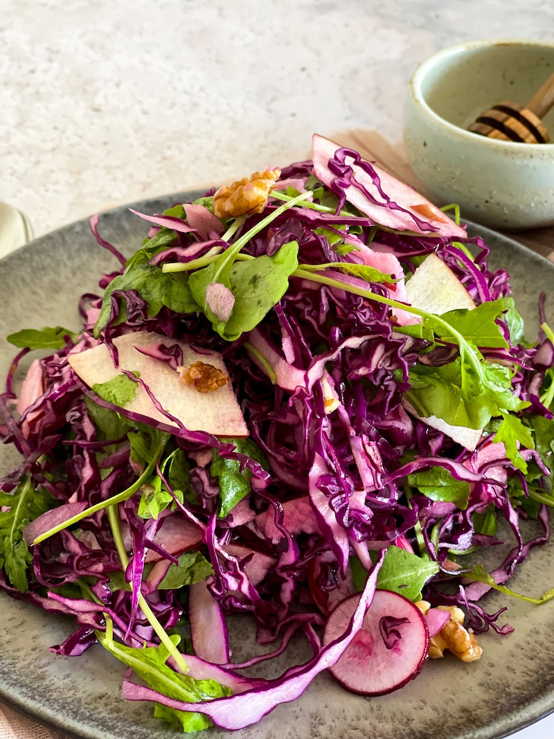 Red Cabbage Apple Slaw on a grey plate