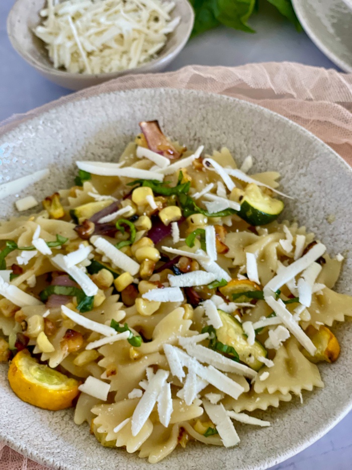 Grilled Veggie pasta in. aplate with salted ricotta on top