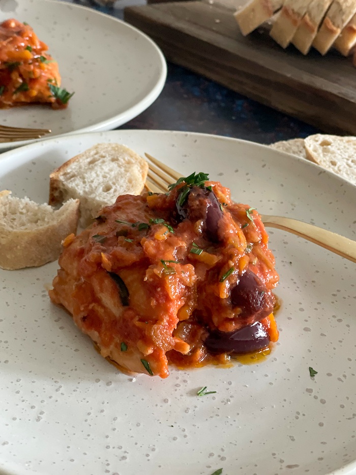 portion of chicken cacciatore on a white stone plate
