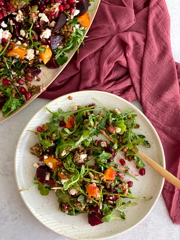 Roasted Beetroot Pumpkin and Lentil Salad on a plate with golden fork