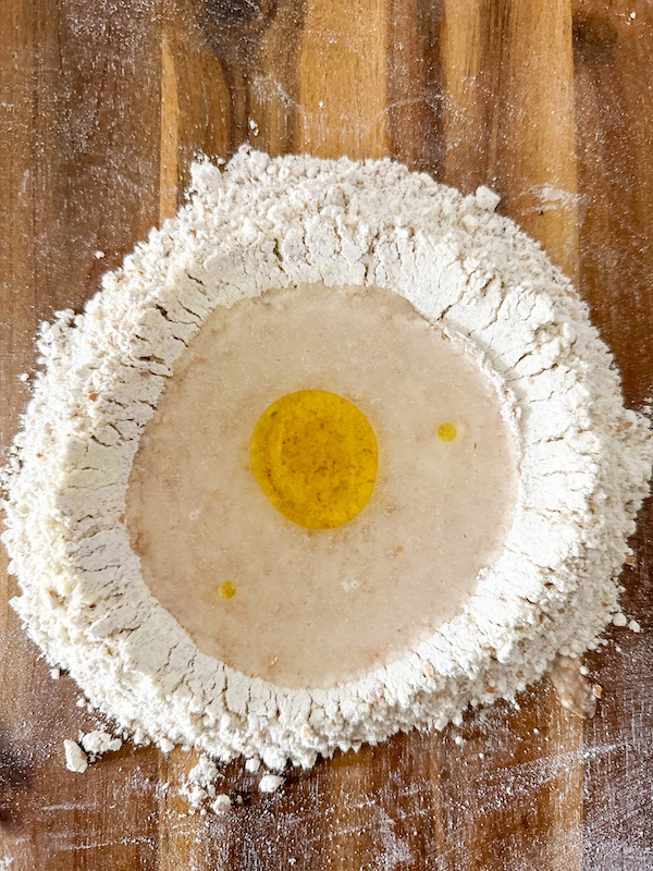 Adding water and olive oil.