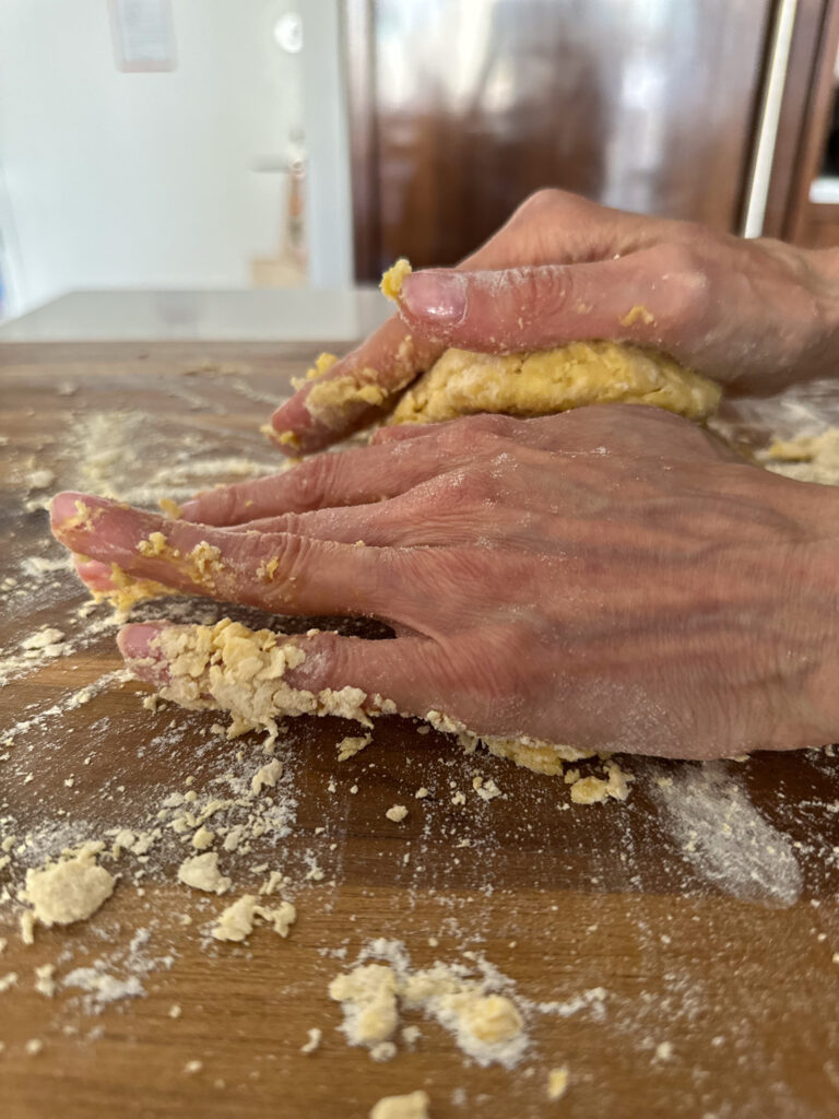 hands working the dough on a floured surface
