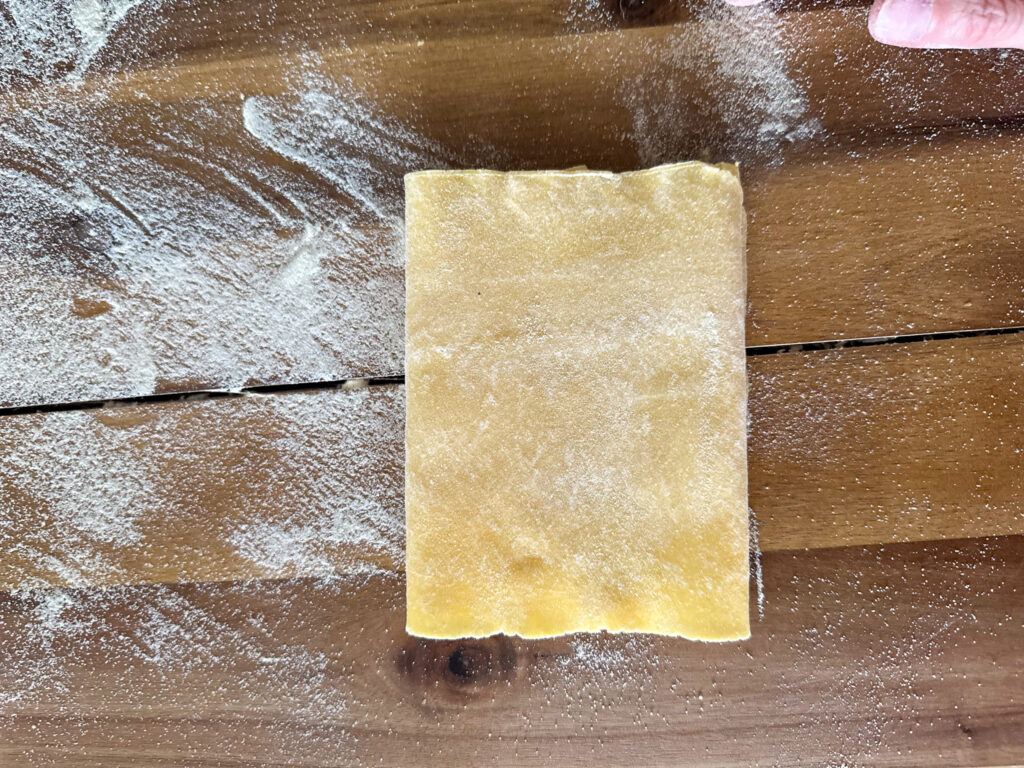 folding pasta sheet in quarter from left to right