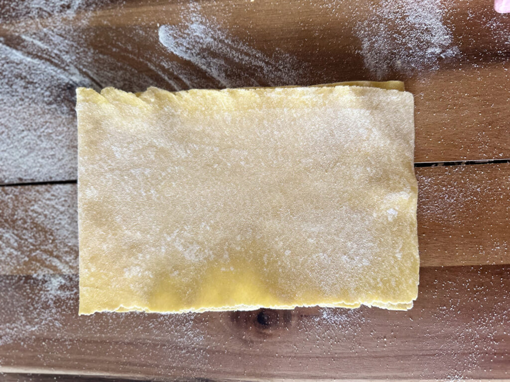 folding pasta sheet in half from left to right
