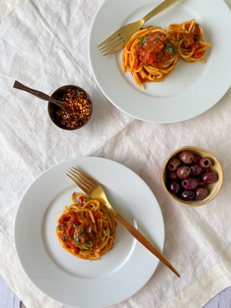 Pasta alla puttanesca in plates