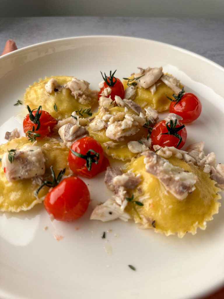 Sea bass ravioli on a white plate