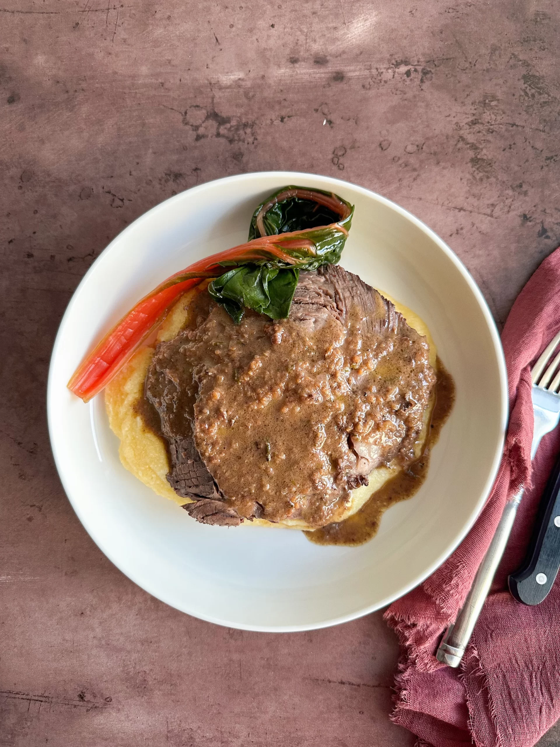 Brasato al Barolo served over polenta and with green chard.