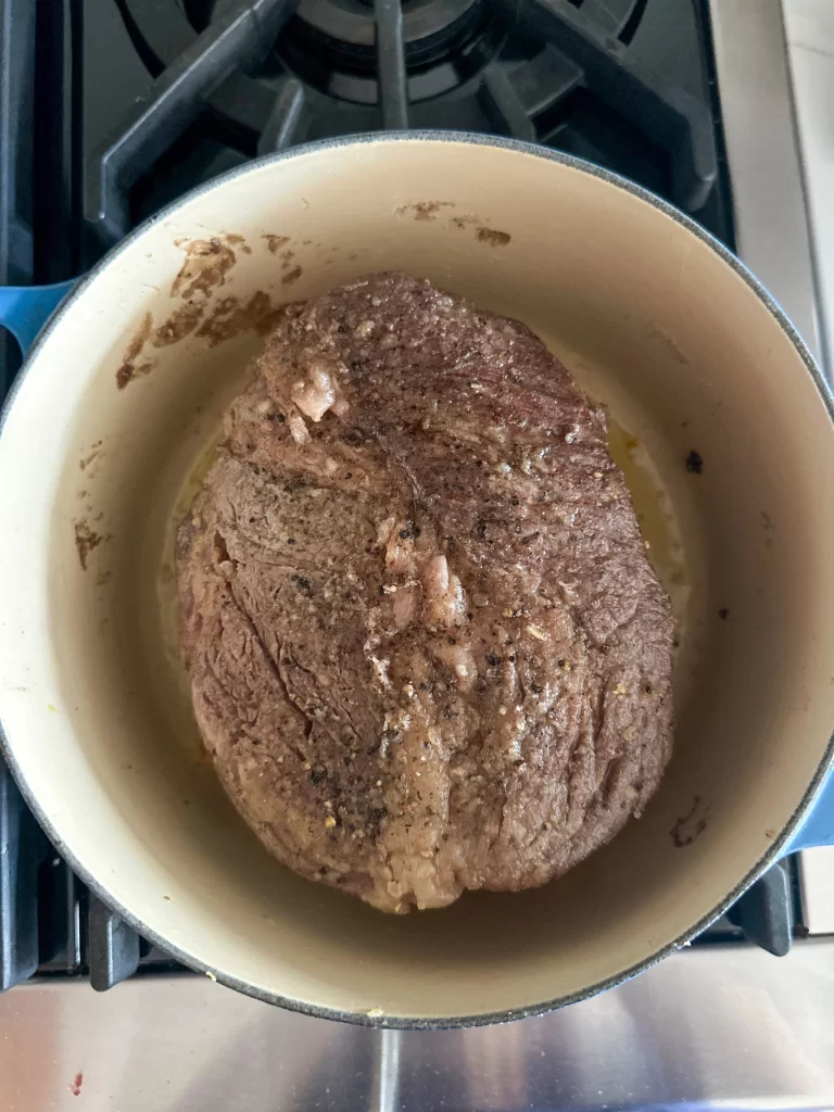 Beef chuck roasted before the slow cooking process