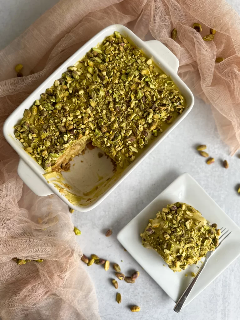 Pistachio Tiramisu in a tray with a plate on the side