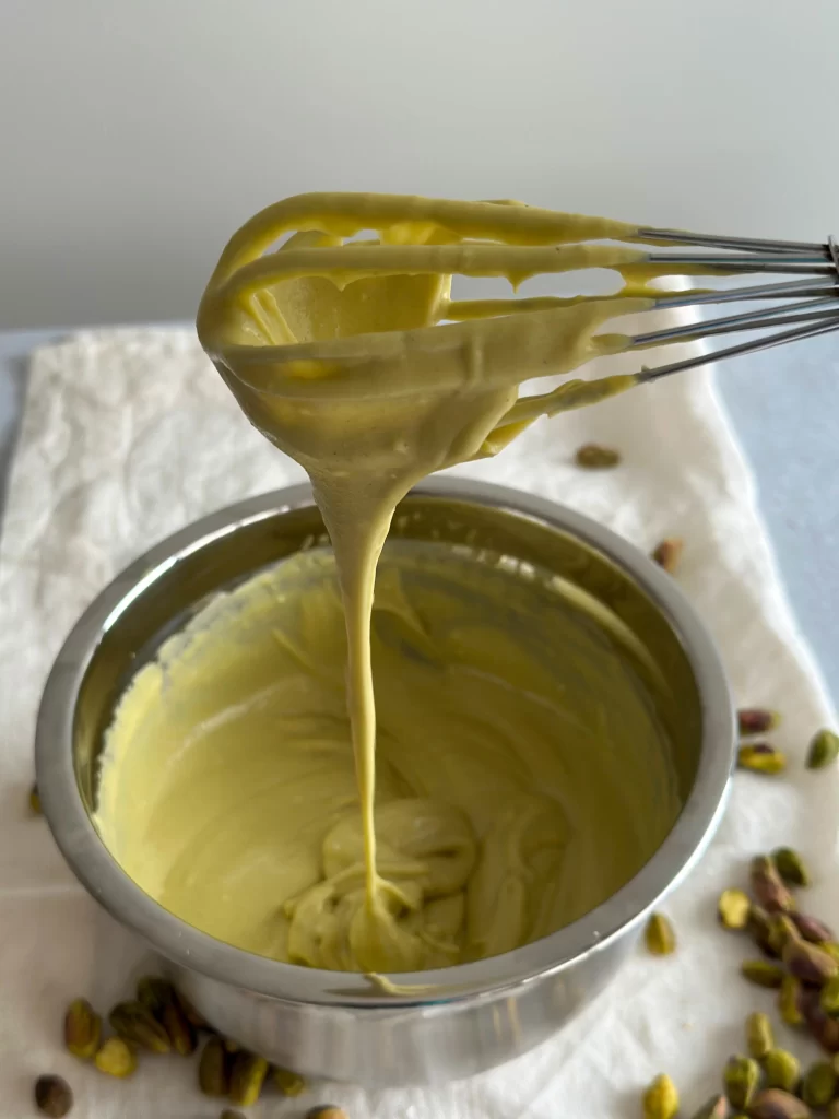 cream of mascara-one pistachio falling into a bowl