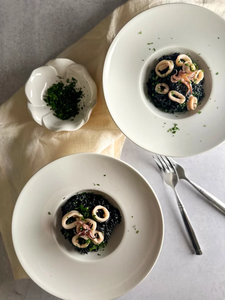 Plates with squid ink risotto