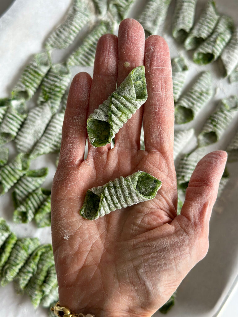 Garganelli in hand over a tray