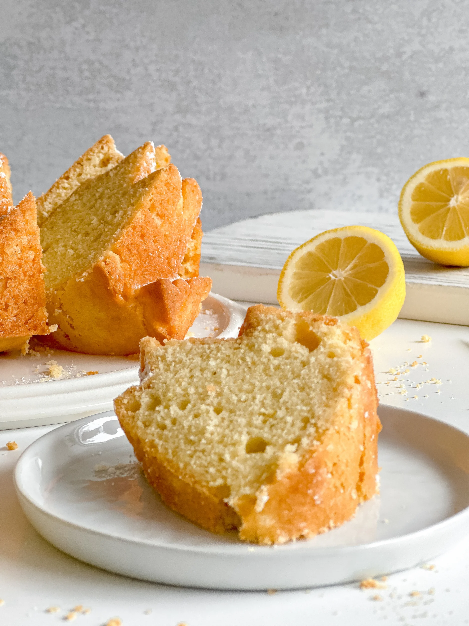 Slice of Lemon Olive Cake with a lemon in background