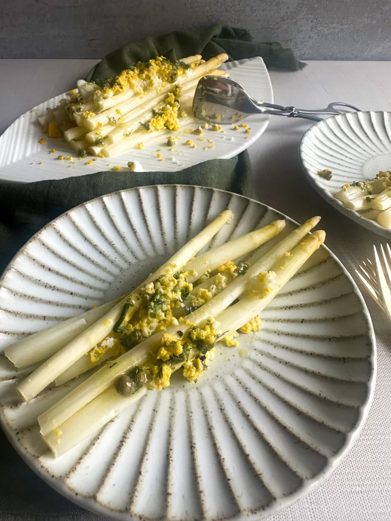 View form 45 degree of a plate with white asparagus and eggs.