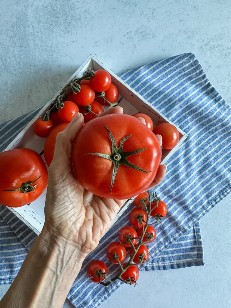 Photo of tomato in hand