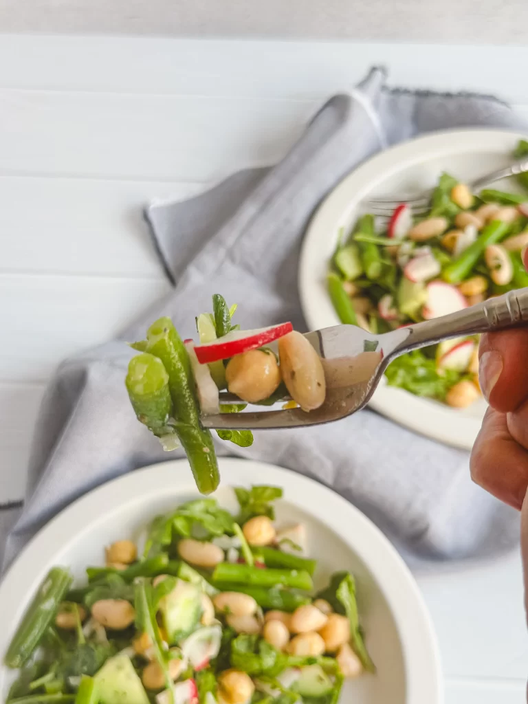 Bite of bean salad on a fork