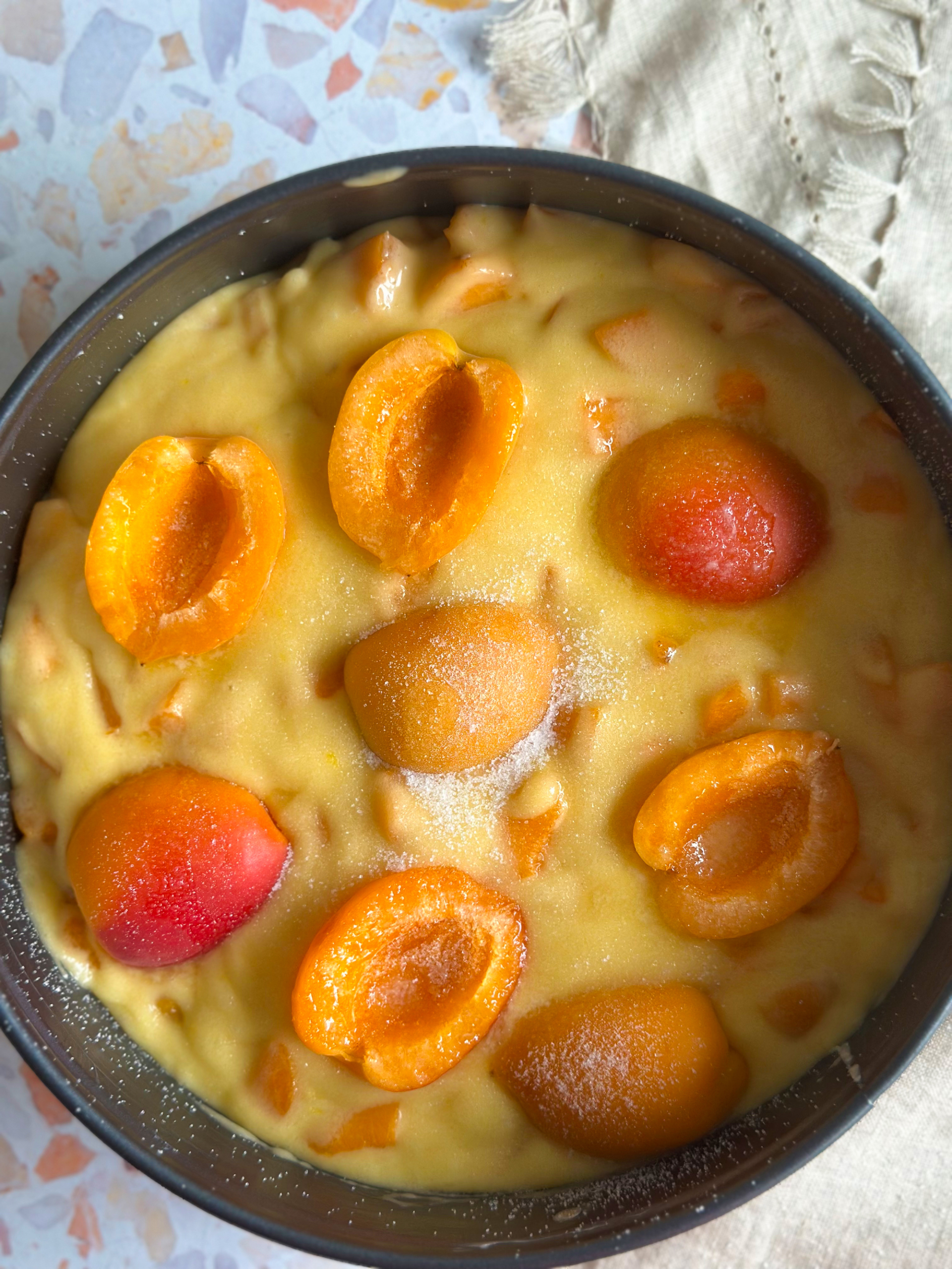 Cake with apricot on top before baking