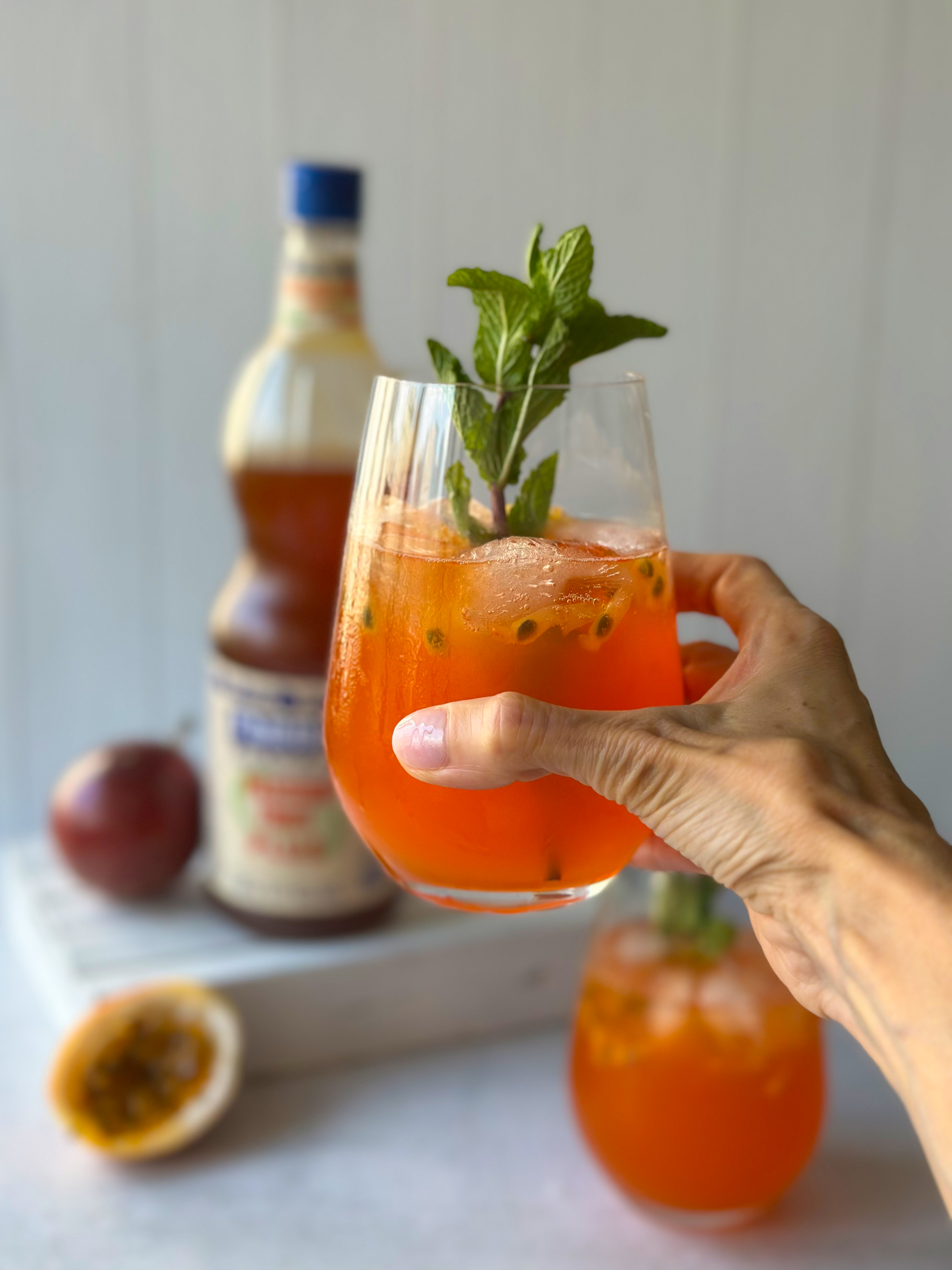 Passion Fruit spritz glass in hand