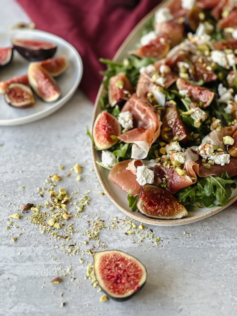 Fig and Prosciutto Salad with a plate of quartered fig
