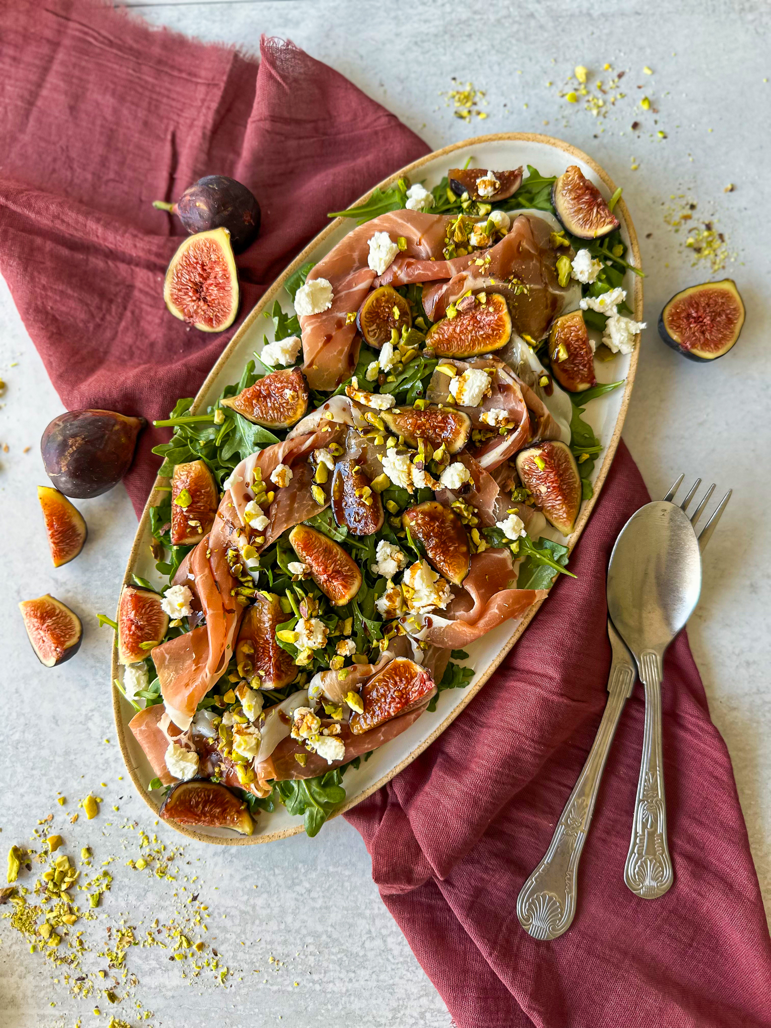 Fig and prosciutto salad on a serving plate