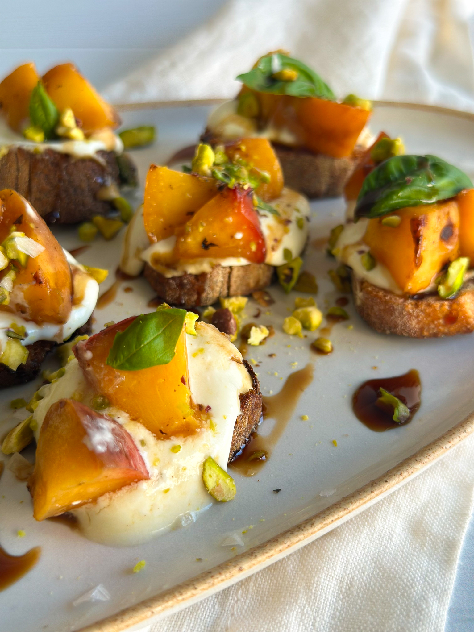Peach bruschetta on an oval tray
