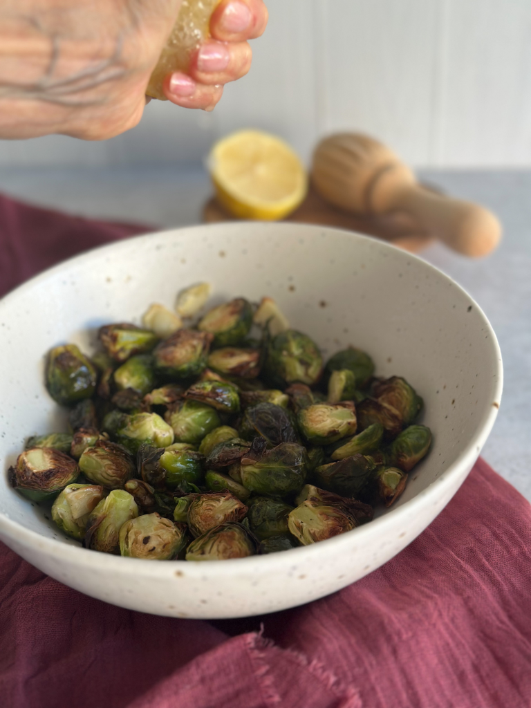 Lemon squeezed over air fried Brussels sprouts
