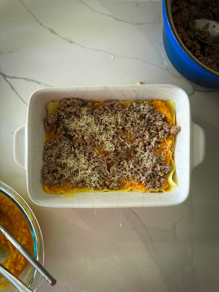 Step 4 adding white bolognese sauce and Parmesan cheese.
