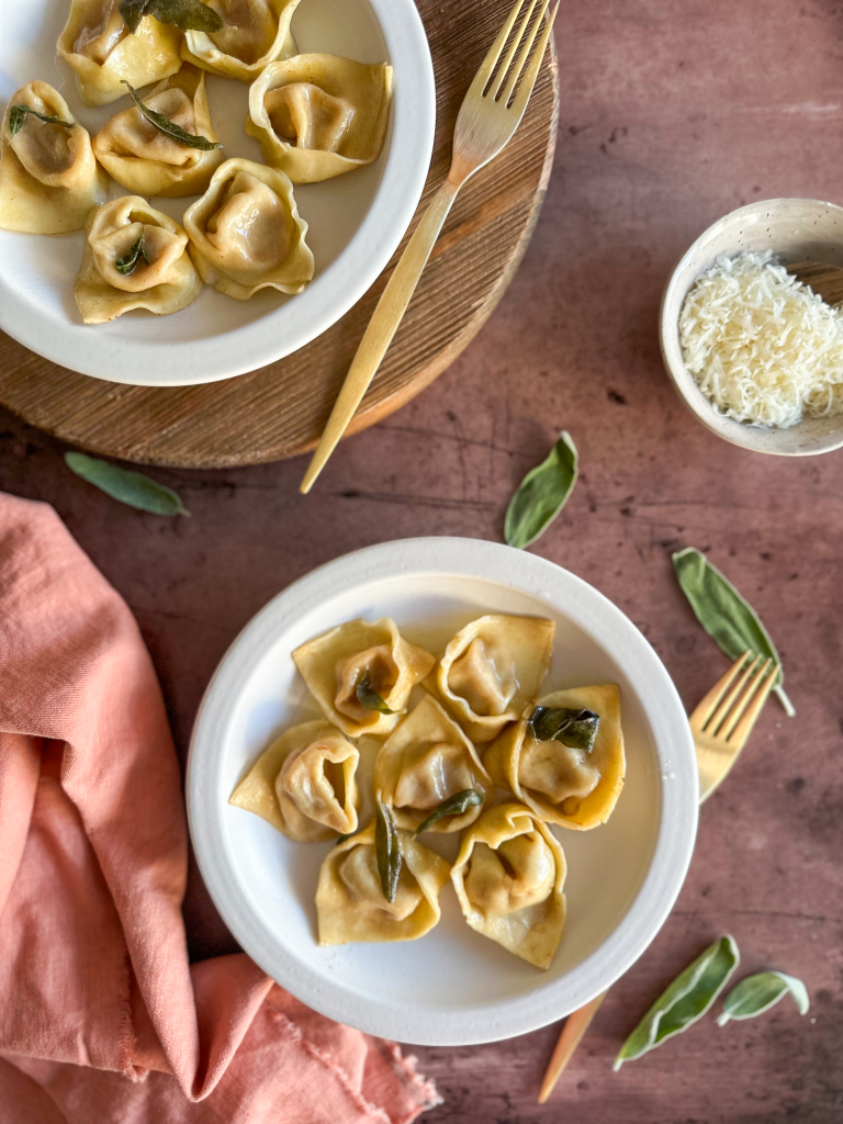 Toss in melted butter and sage, served with Parmesan