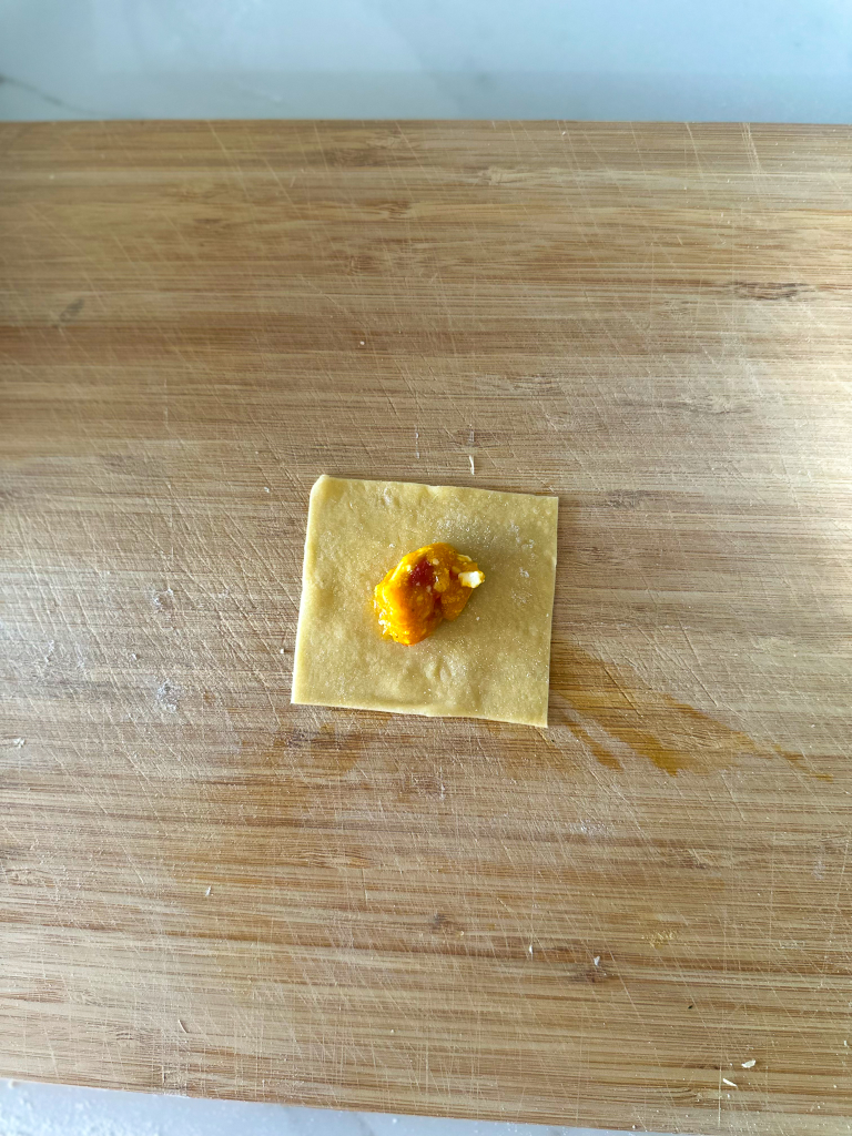 Filling in one square of pasta