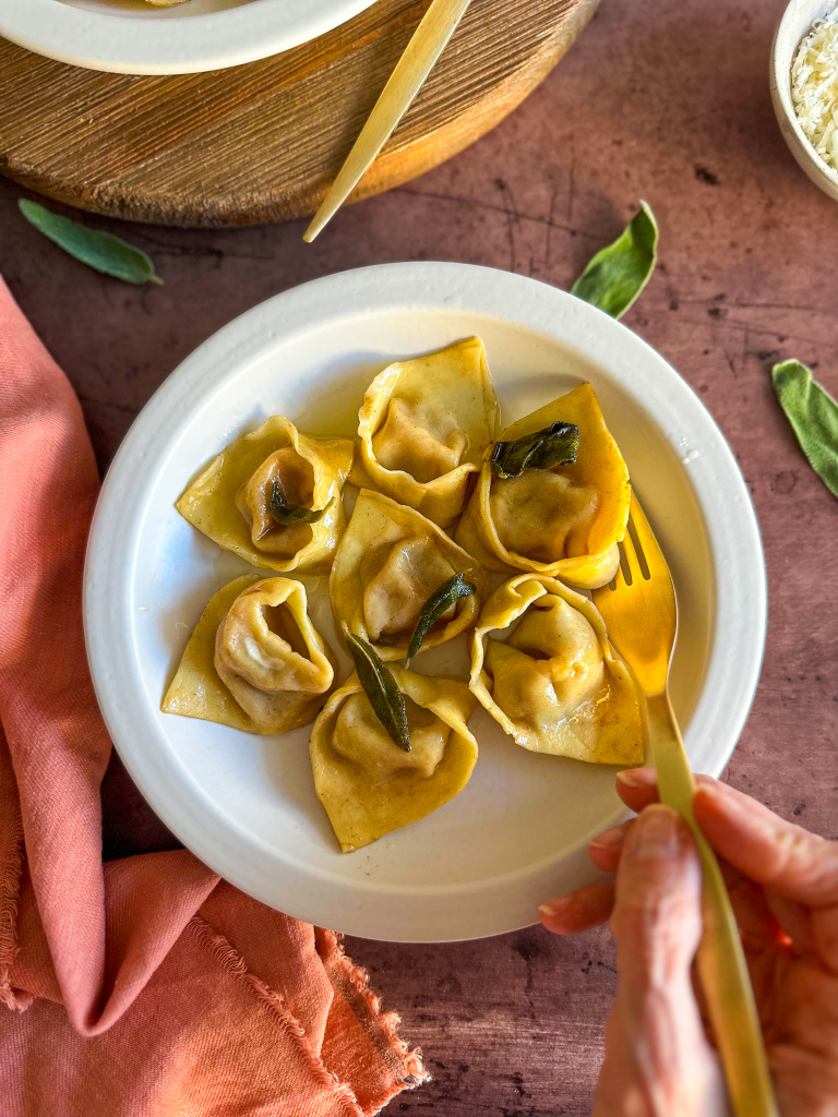 Fork in hand eating tortelli di zucca