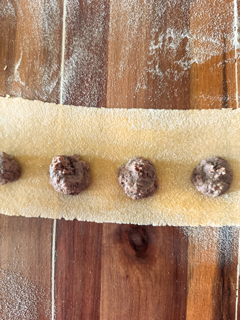 Pasta sheet with little molds of filling