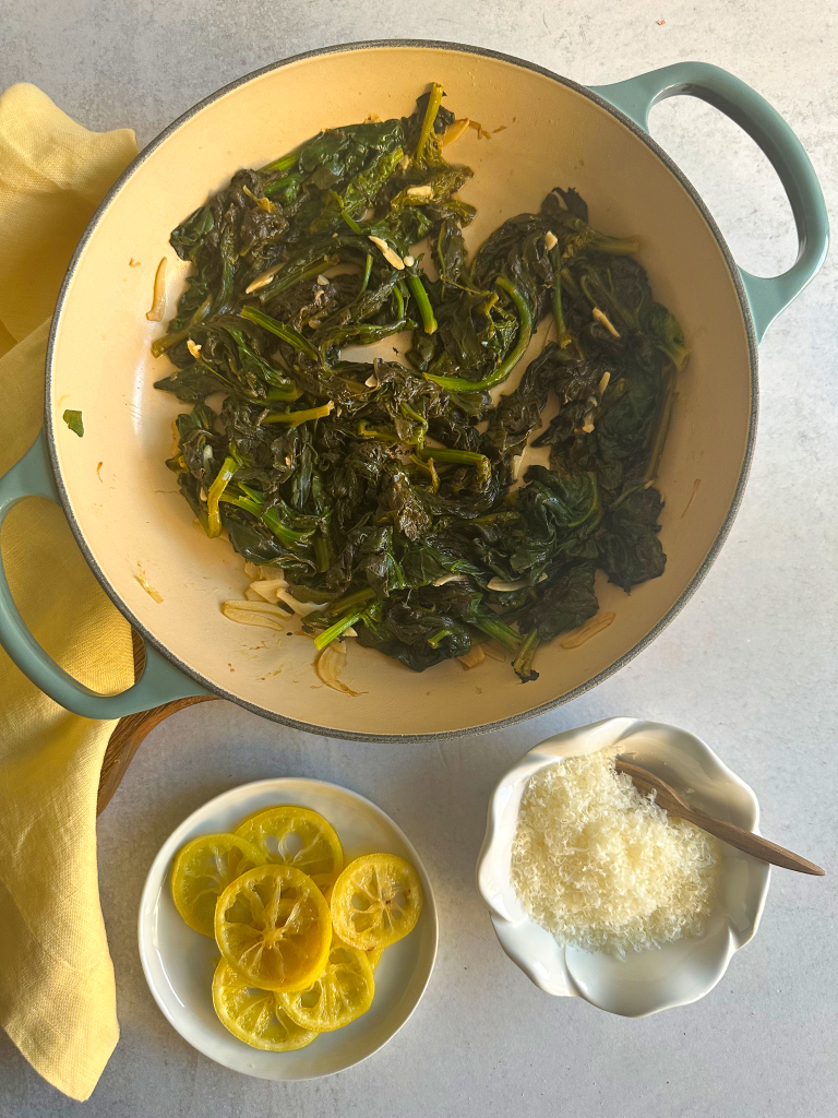 Spinach Sautéed in the pan, with lemon slices and Parmesan.