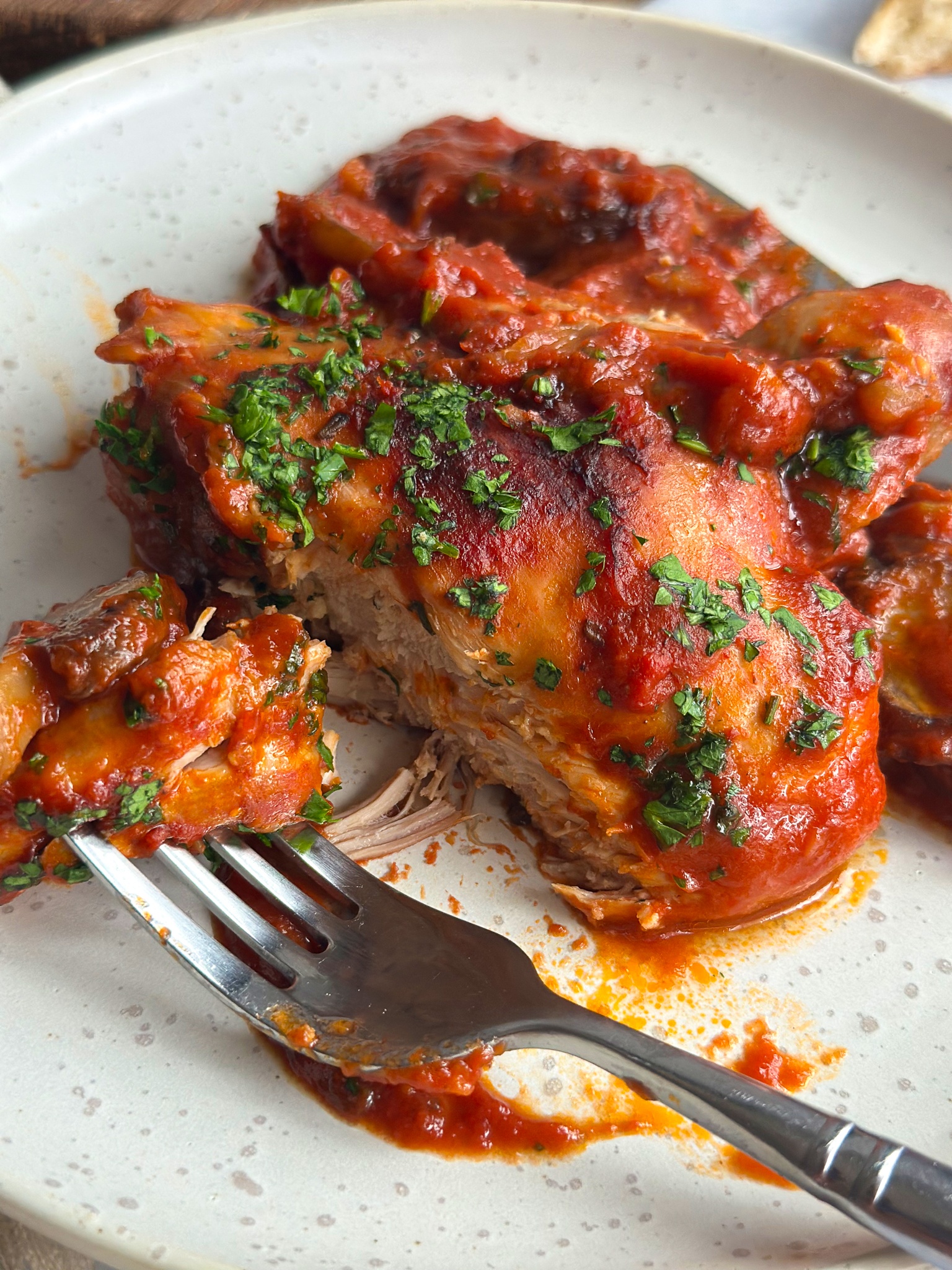 close up of chicken with abite next to a fork