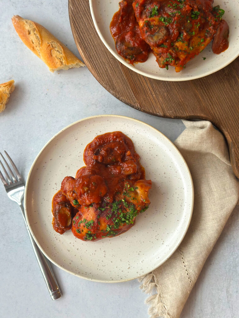 Chicken cacciatora on a white plate