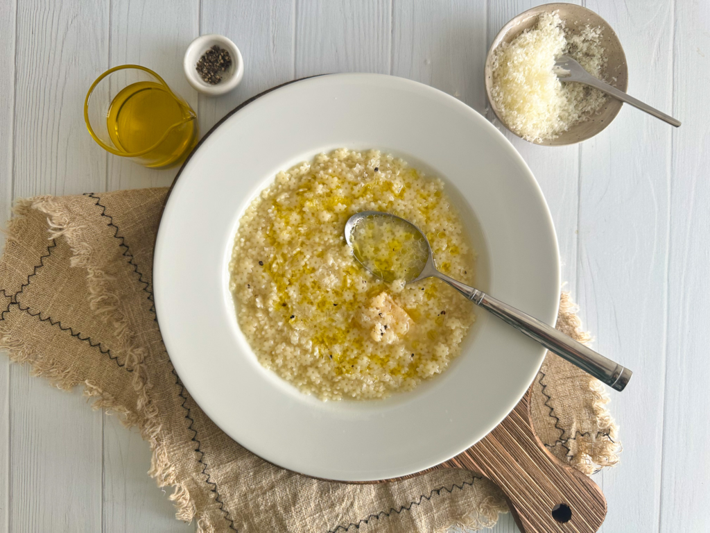 Pastina Soup in a plate over a wood board