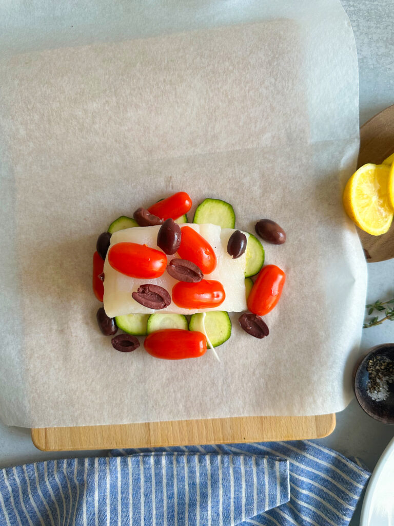 adding tomatoes, olives, onions
